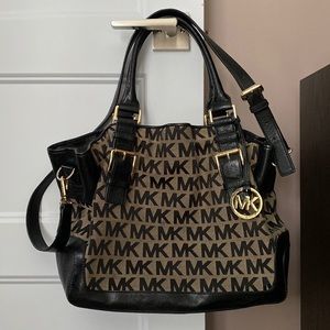 Michael Kors beige and black monogrammed crossbody bag.